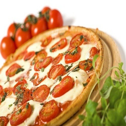 low, tilted view of pizza margarita, oregano in foreground, tomatos in background پیتزا باب اسفنجی خرم آباد